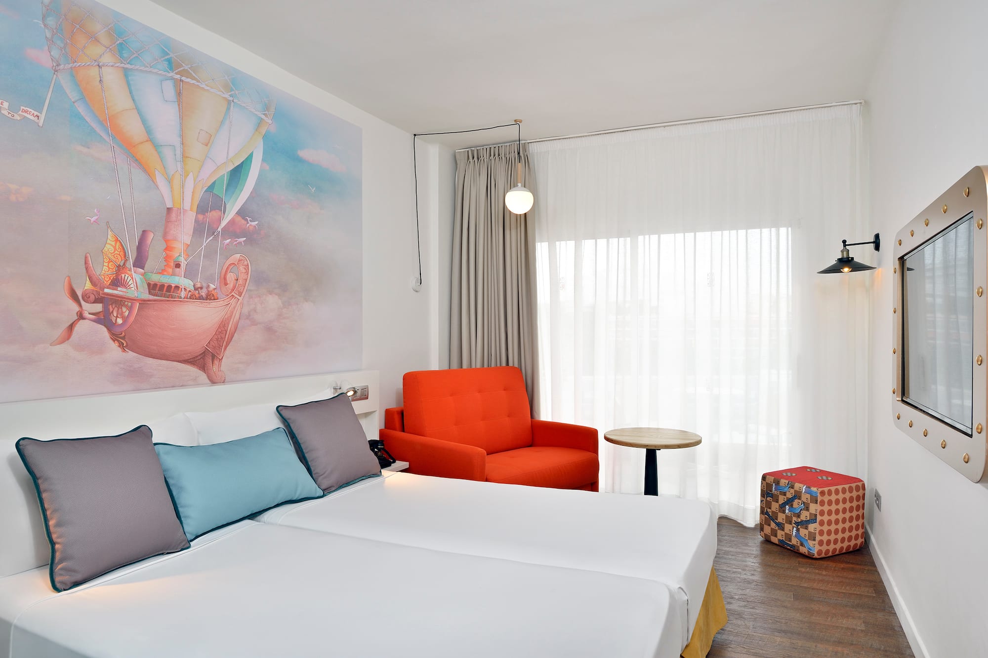 a room with two beds and a chair