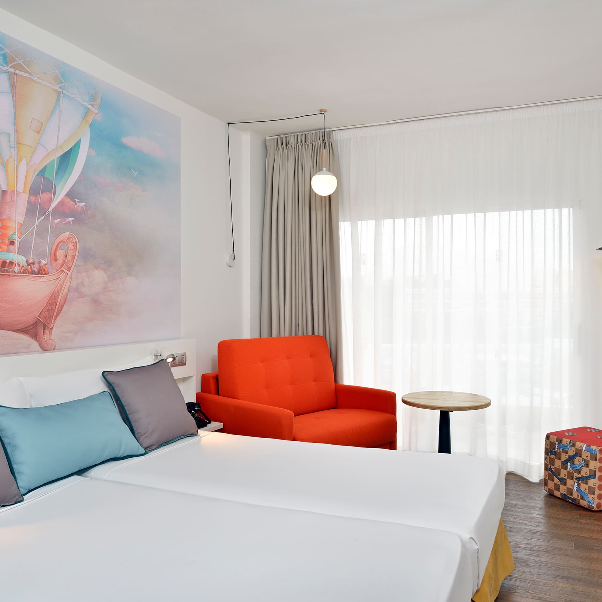 a room with two beds and a chair