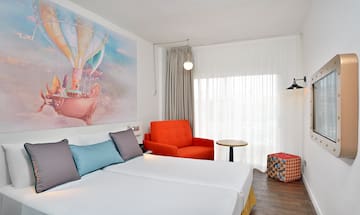 a room with two beds and a chair