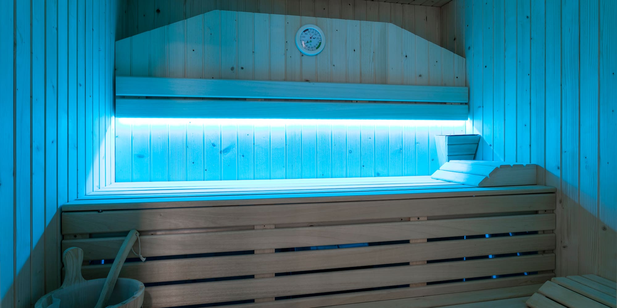 a wooden sauna with a bucket and a bucket