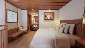 a bedroom with a bed and a painting on the wall