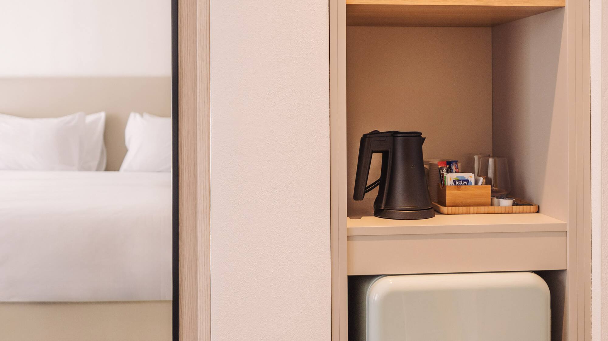 a small refrigerator in a shelf