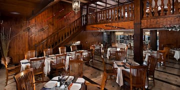 a restaurant with wooden walls and stairs