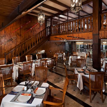 a restaurant with wooden walls and stairs