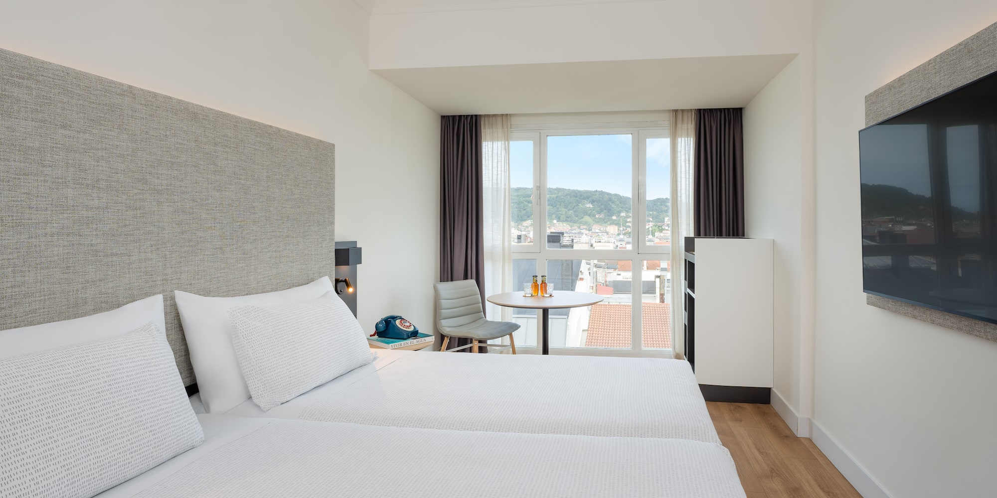 a room with two beds and a table