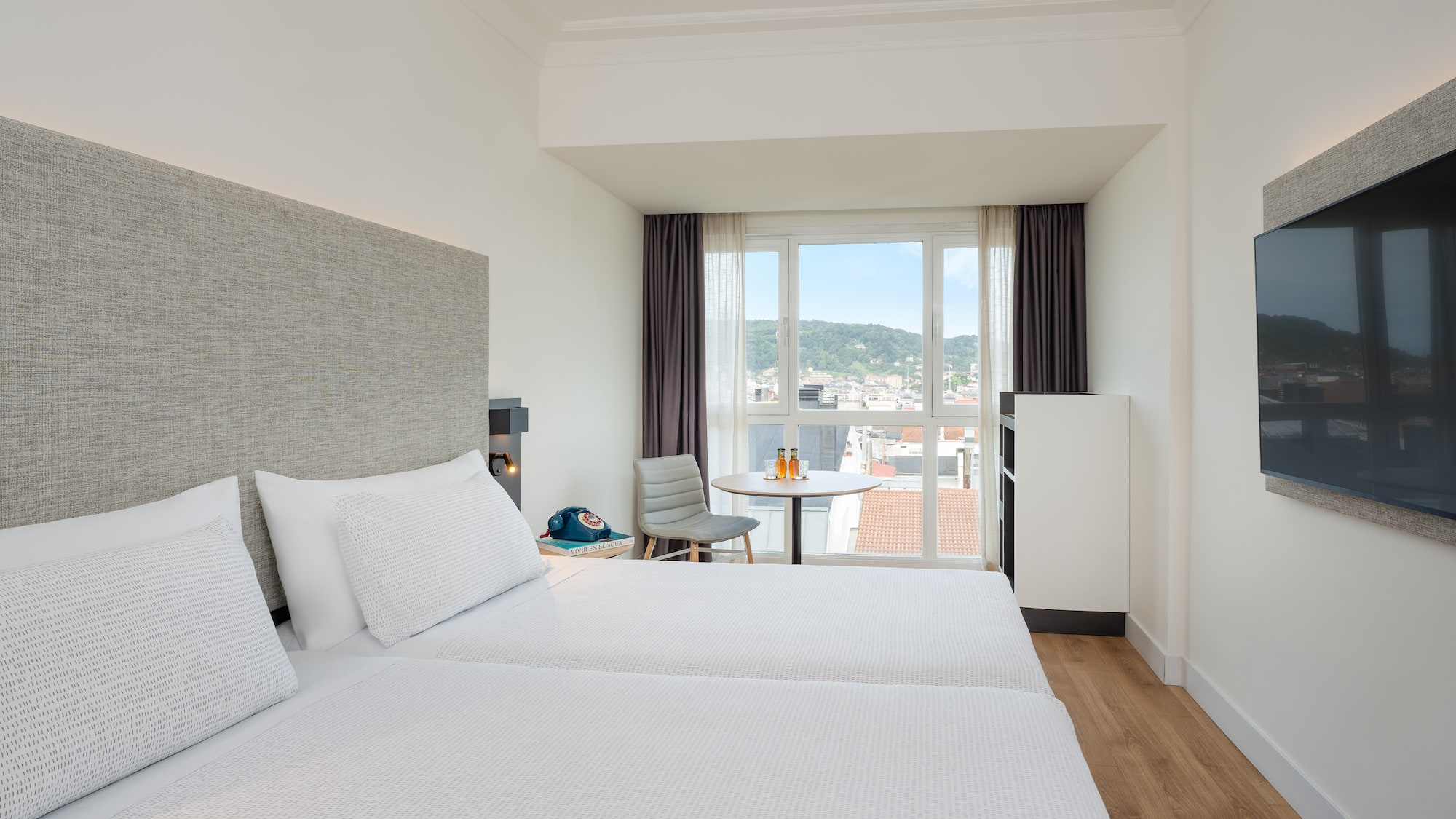 a room with two beds and a table