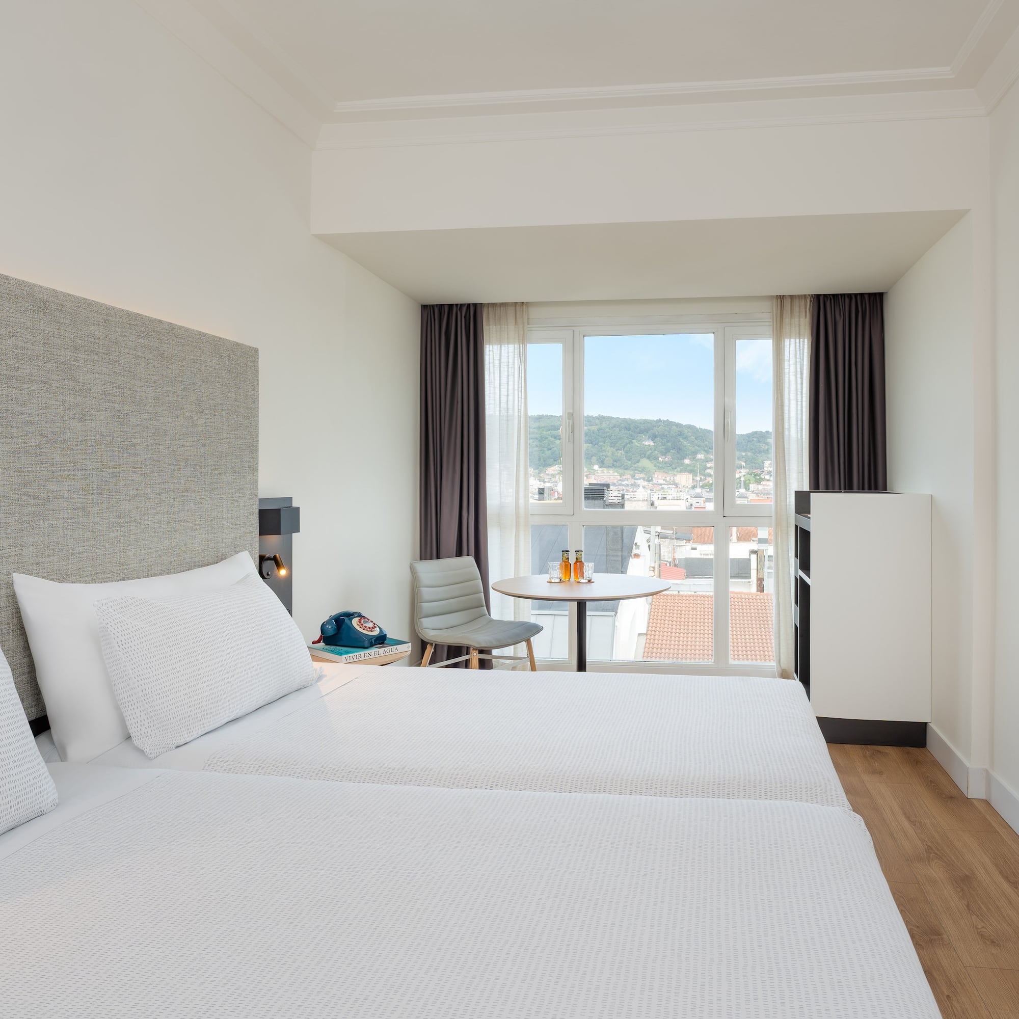 a room with two beds and a table