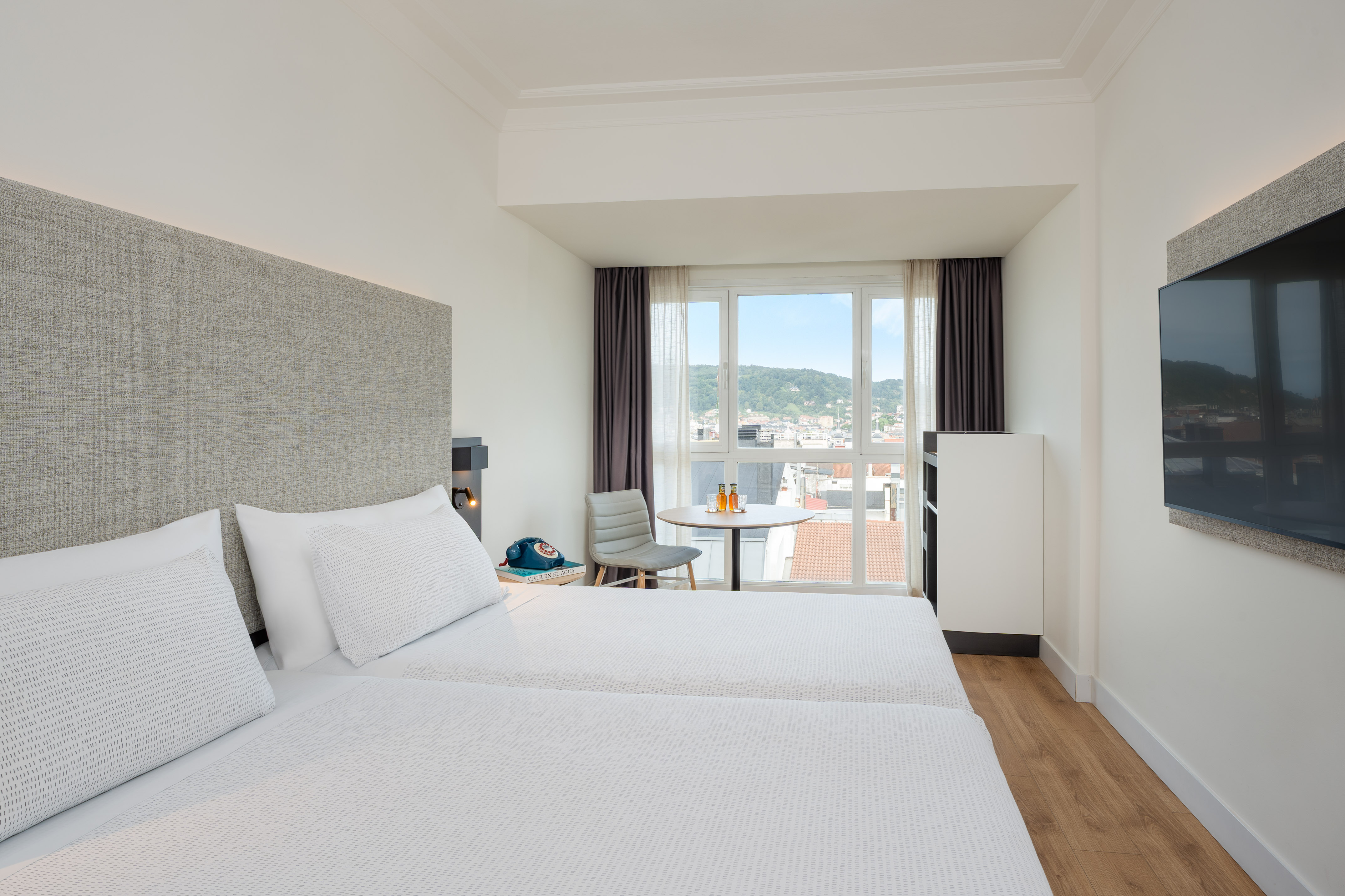 a room with two beds and a table