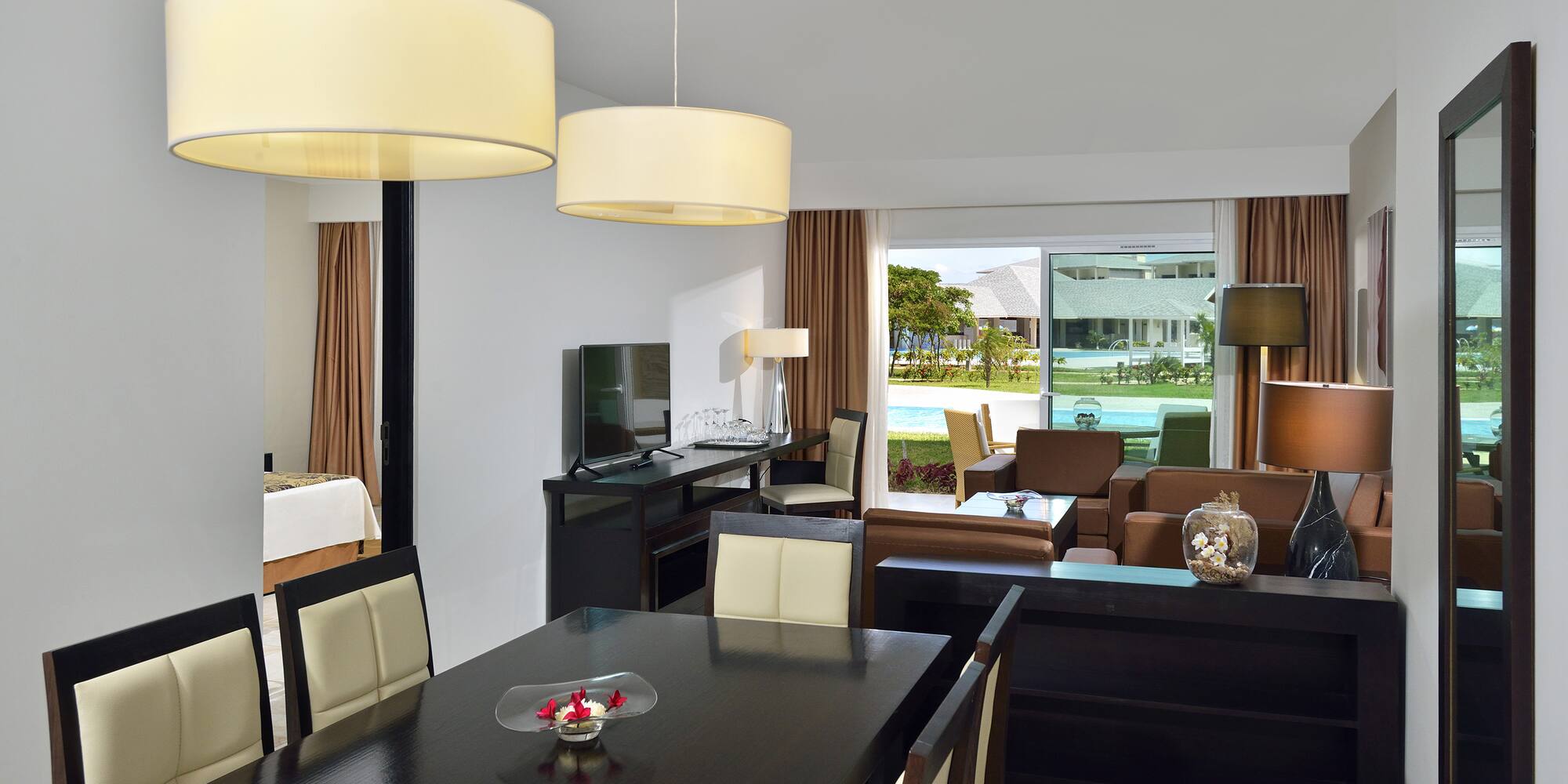 a room with a table and chairs and a television