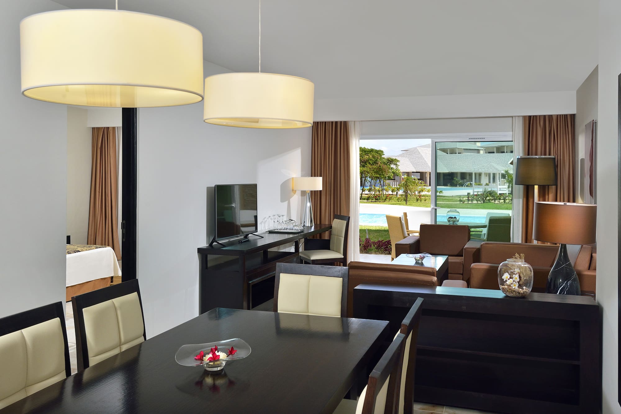 a room with a table and chairs and a television