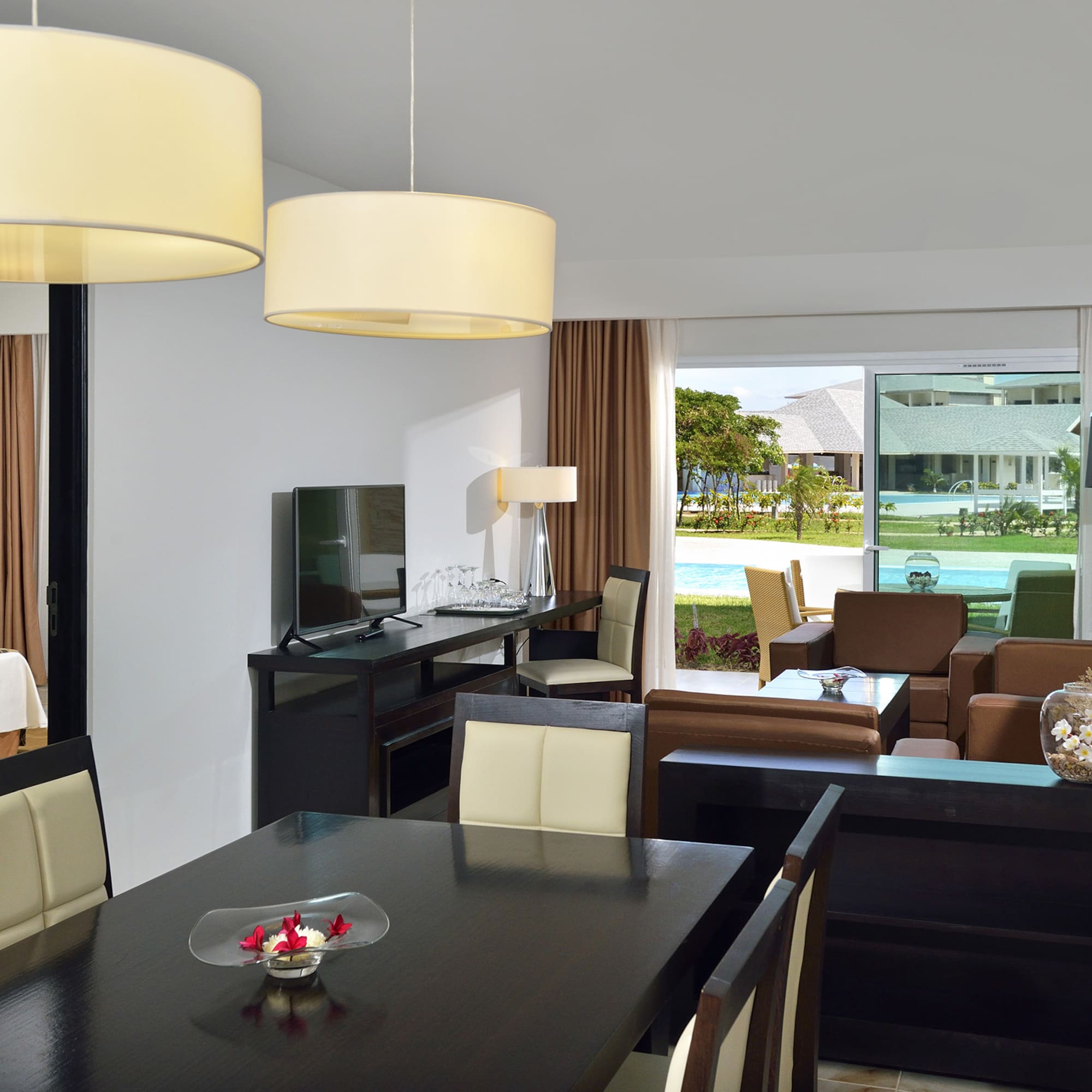 a room with a table and chairs and a television