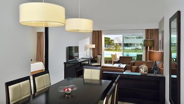 a room with a table and chairs and a television