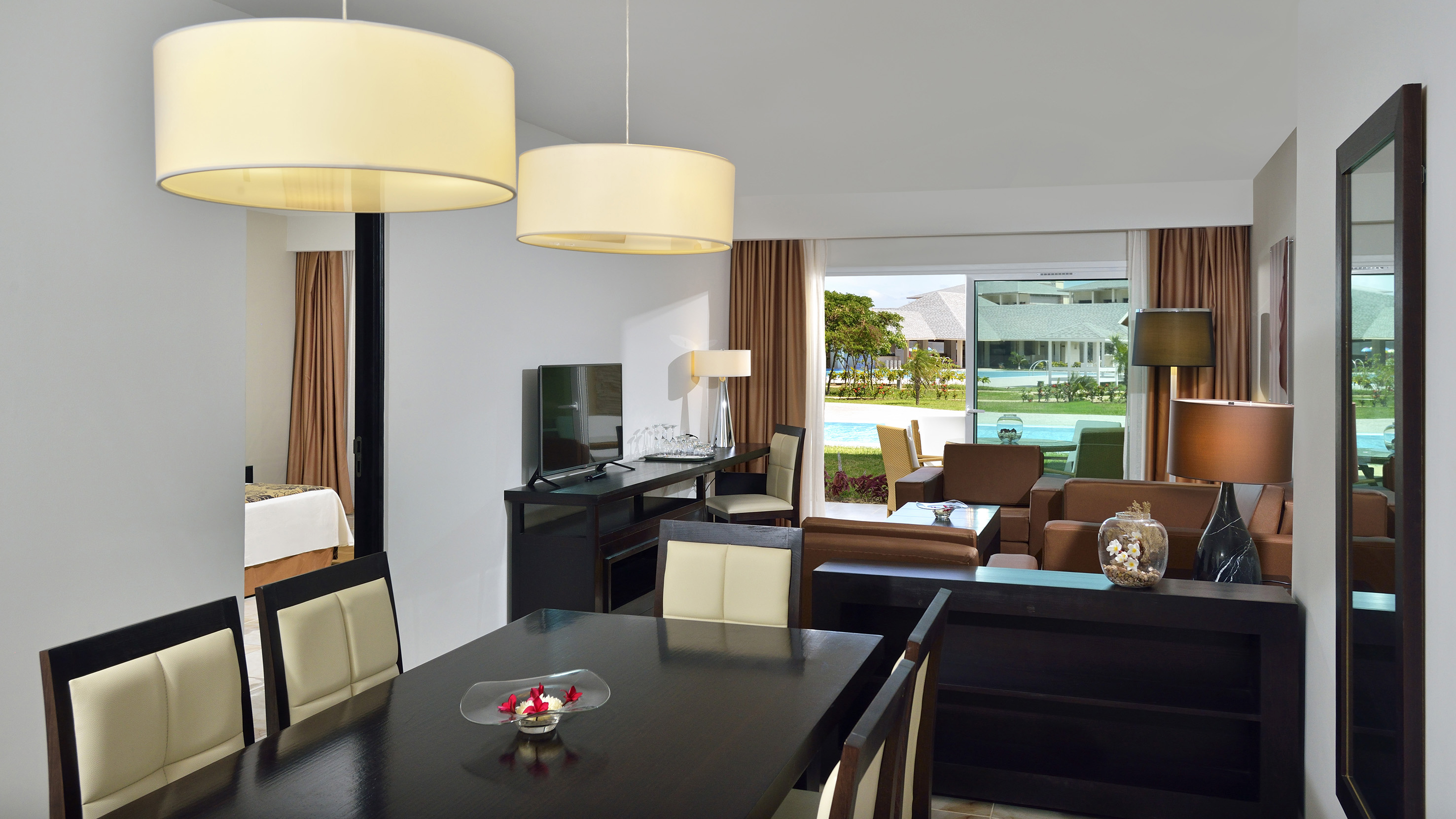 a room with a table and chairs and a television