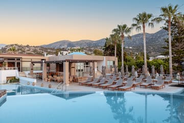 a pool with chairs and umbrellas