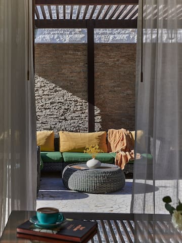 a patio with a couch and a coffee table