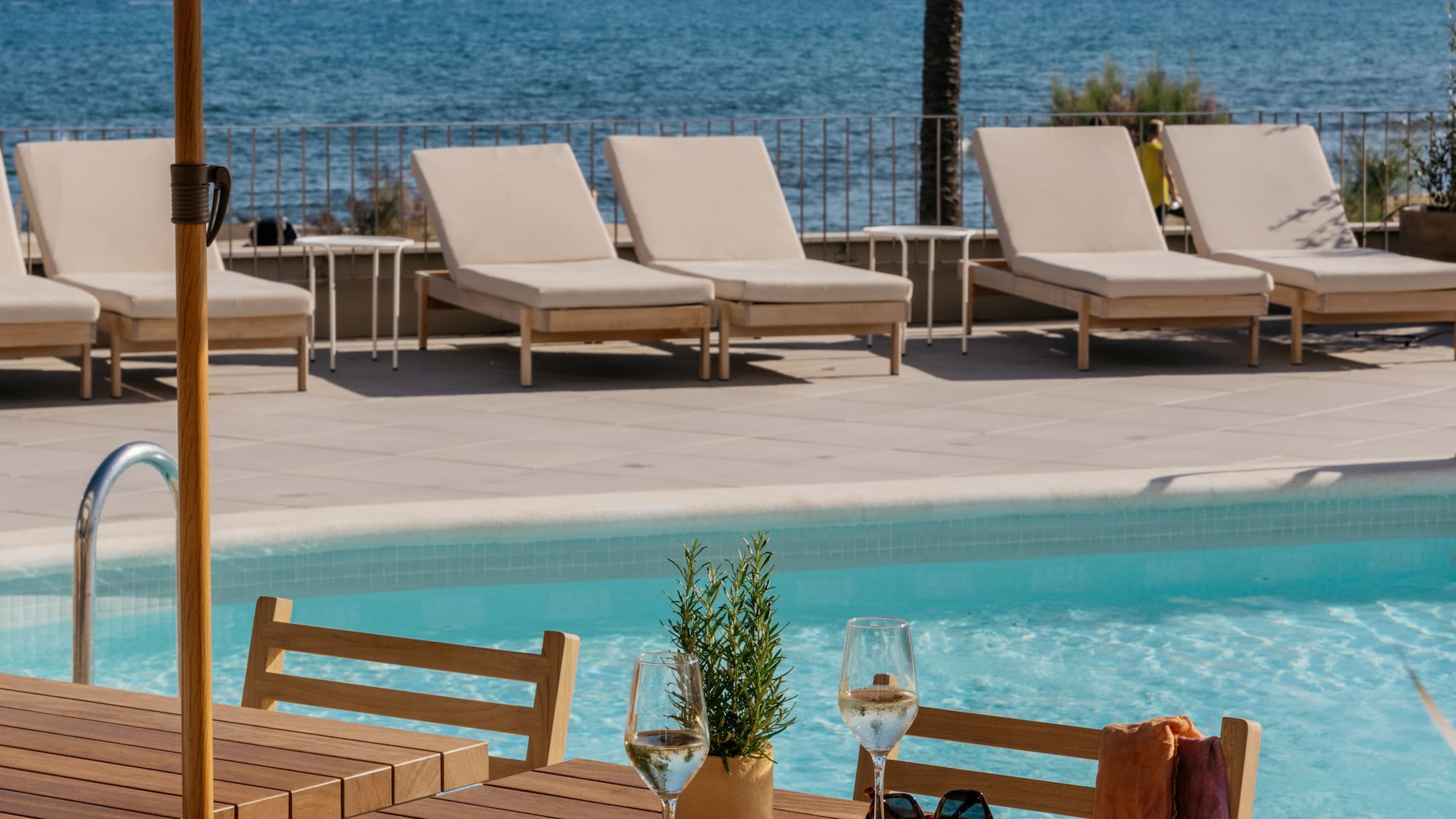 a table and chairs by a pool