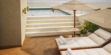 a pool with a deck chair and umbrella