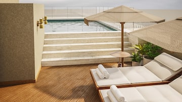 a pool with a deck chair and umbrella