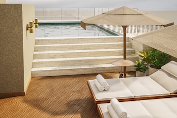 a pool with a deck chair and umbrella