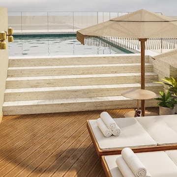 a pool with a deck chair and umbrella