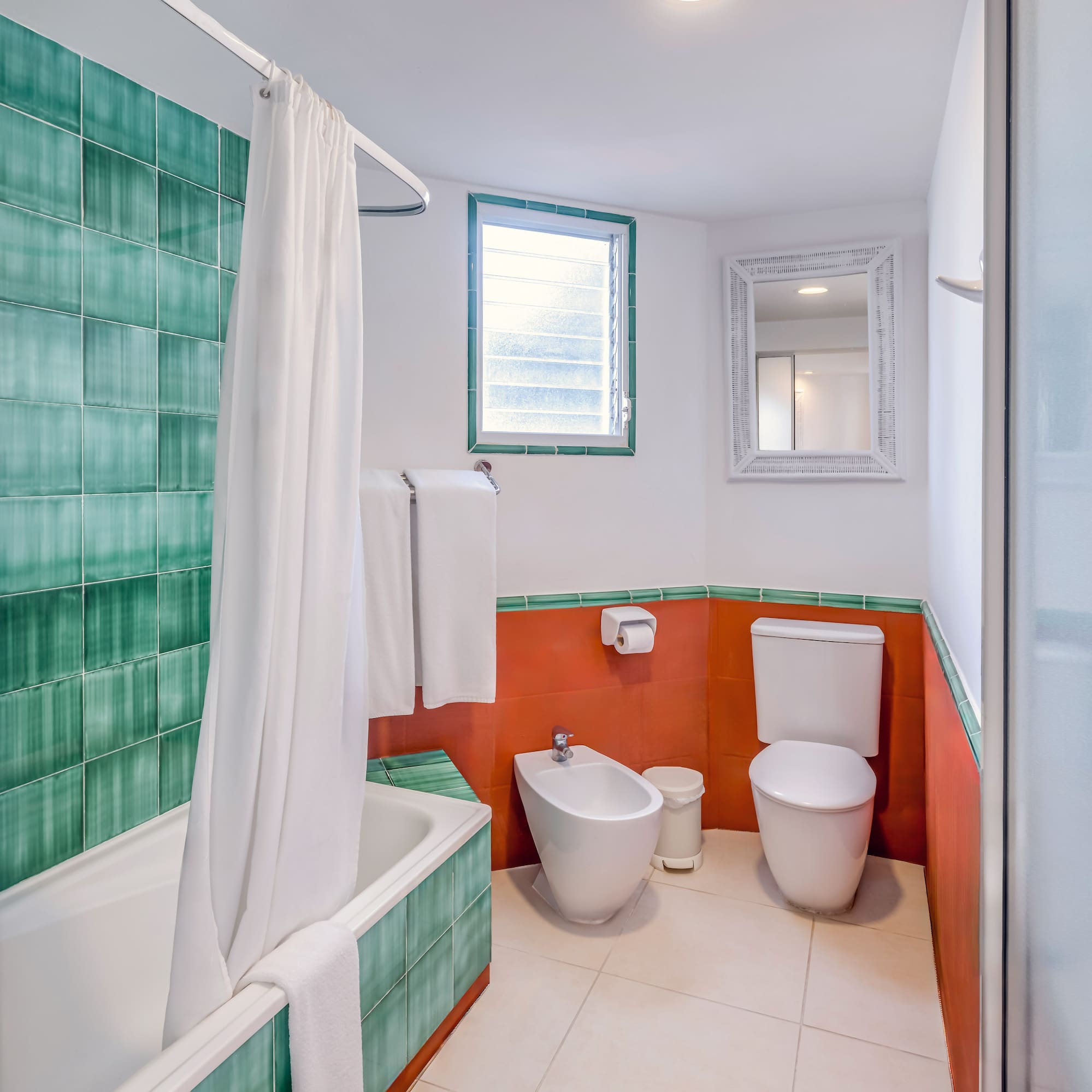 a bathroom with a toilet and bathtub