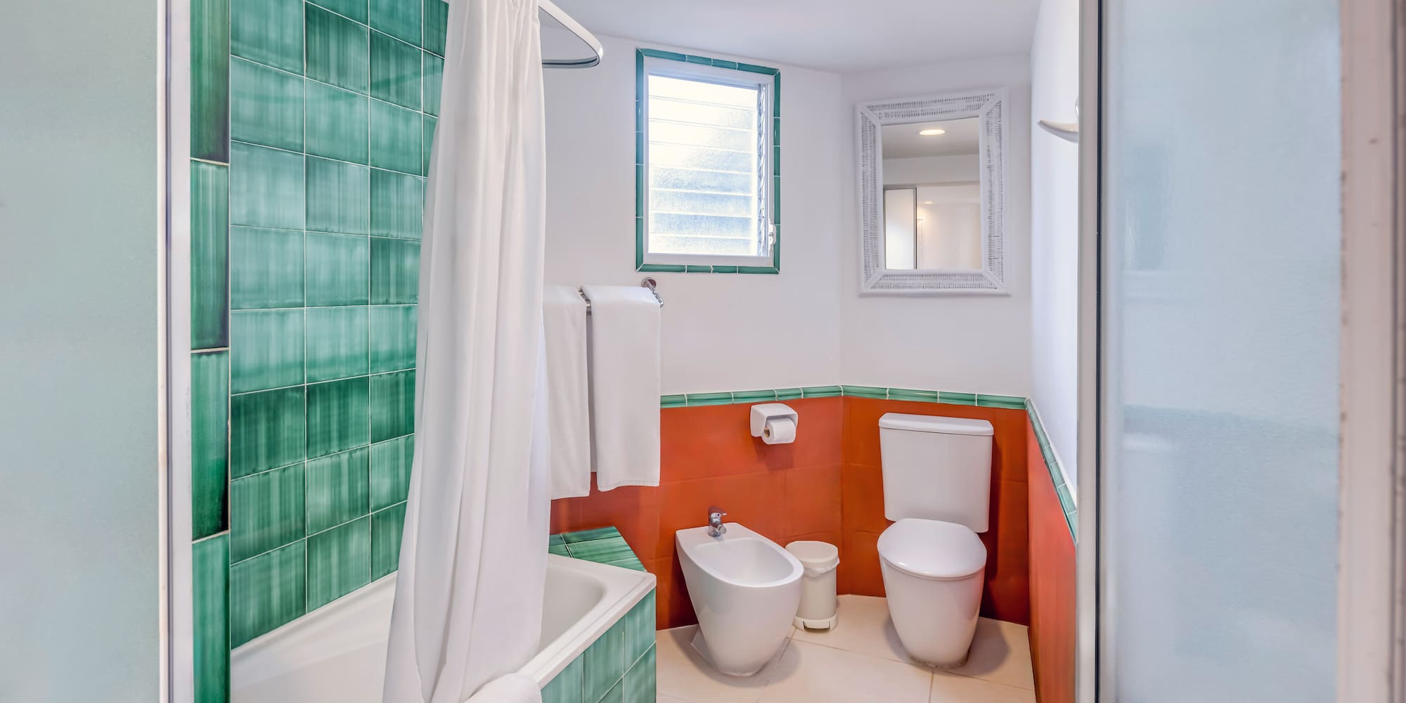 a bathroom with a toilet and bathtub