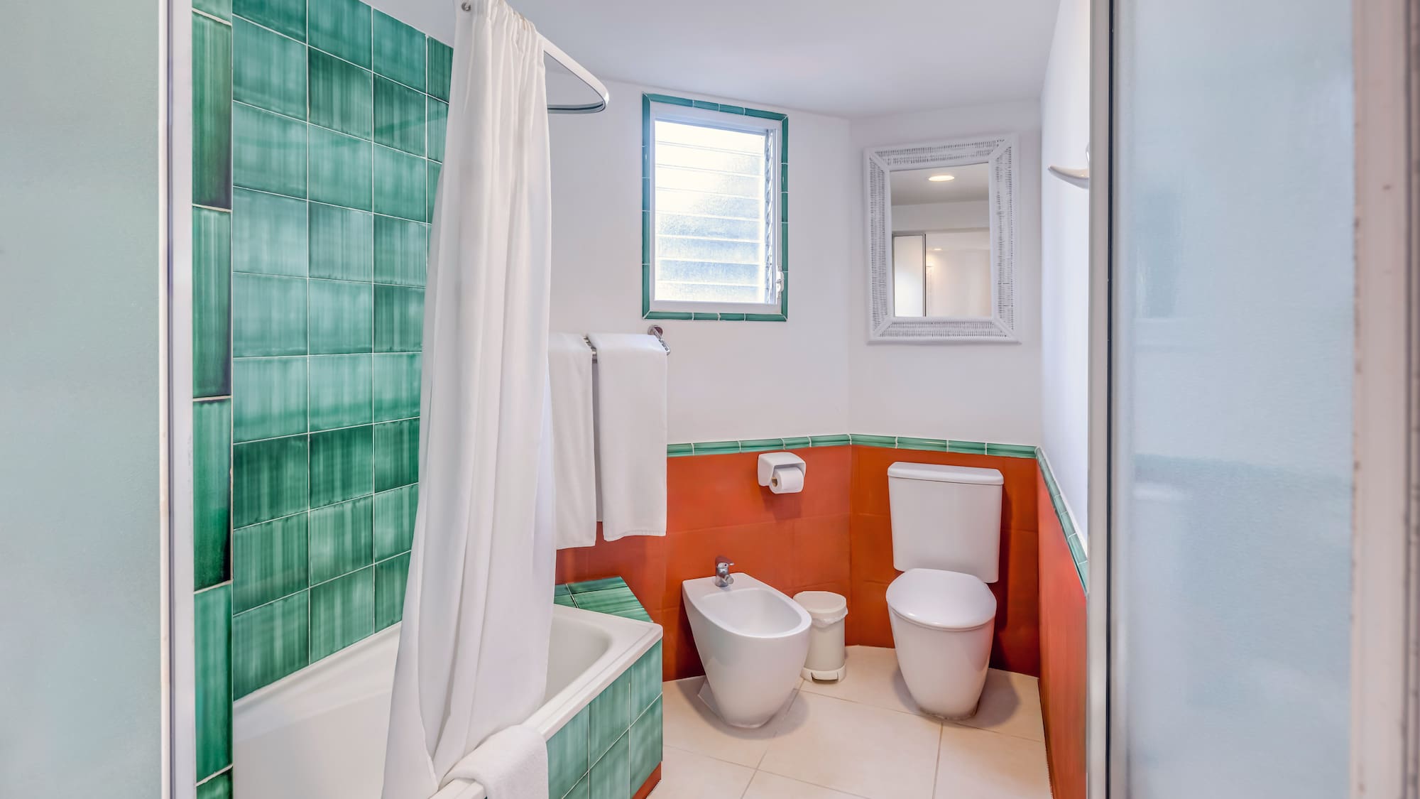a bathroom with a toilet and bathtub