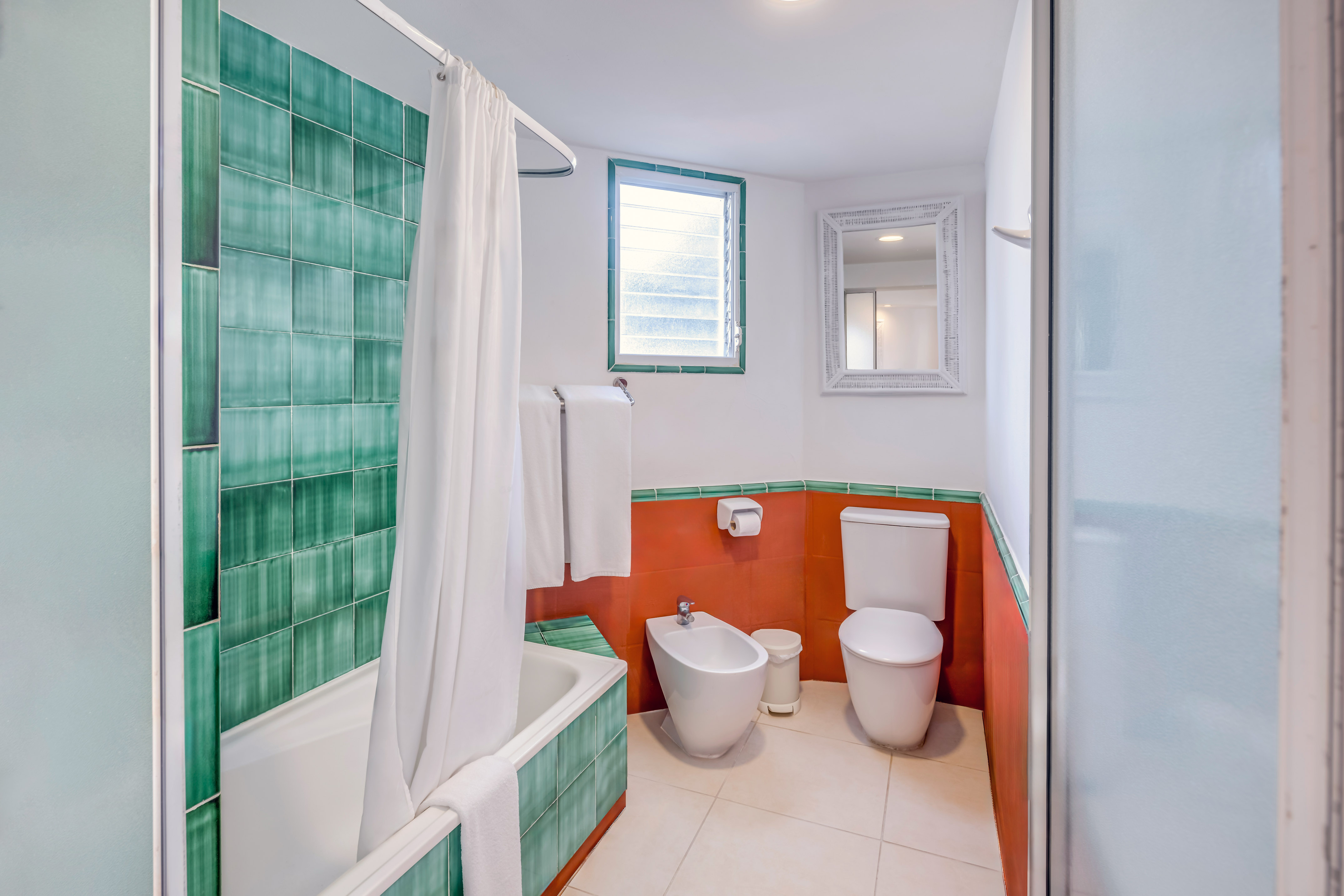 a bathroom with a toilet and bathtub