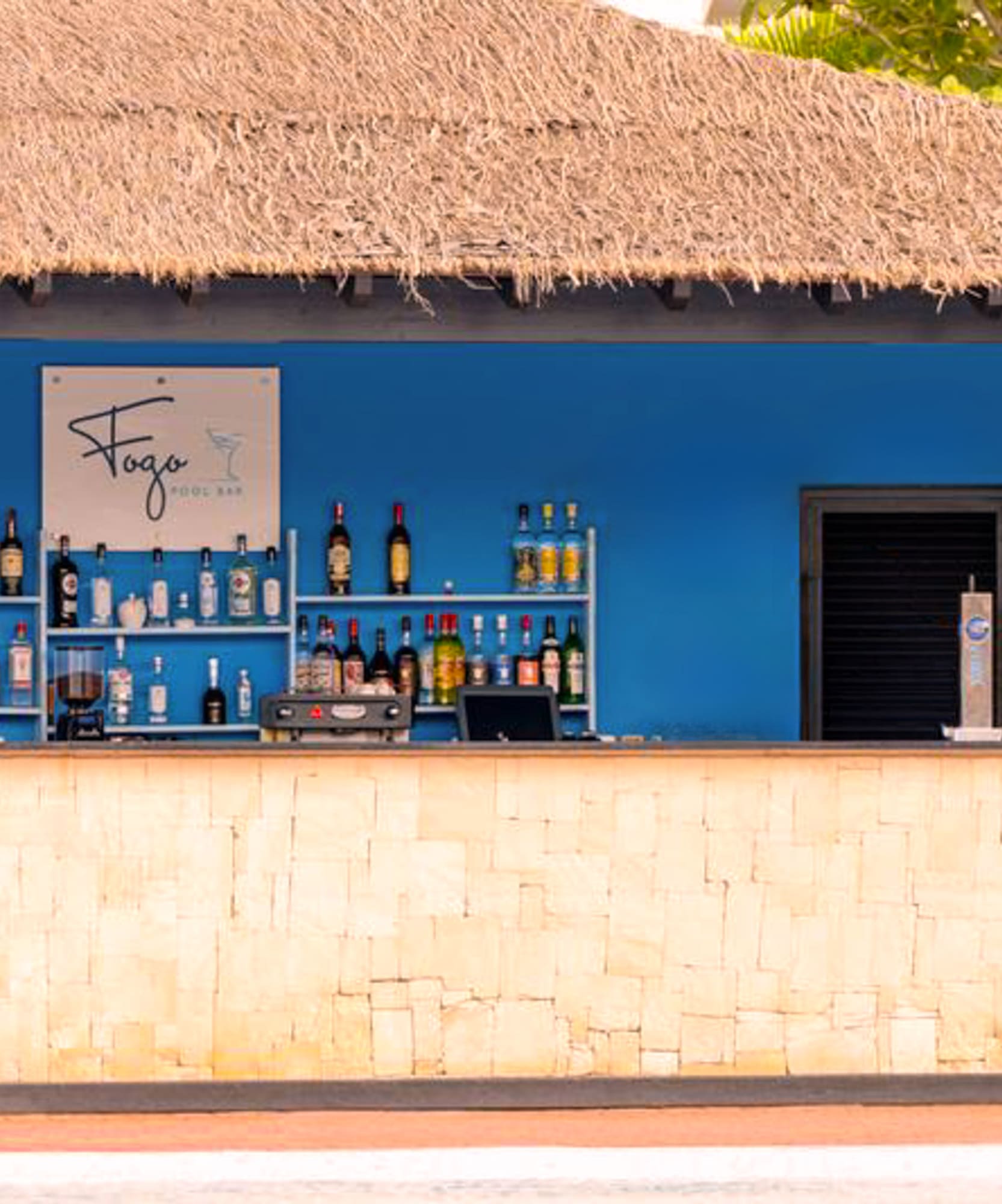 a bar with bottles of alcohol on shelves