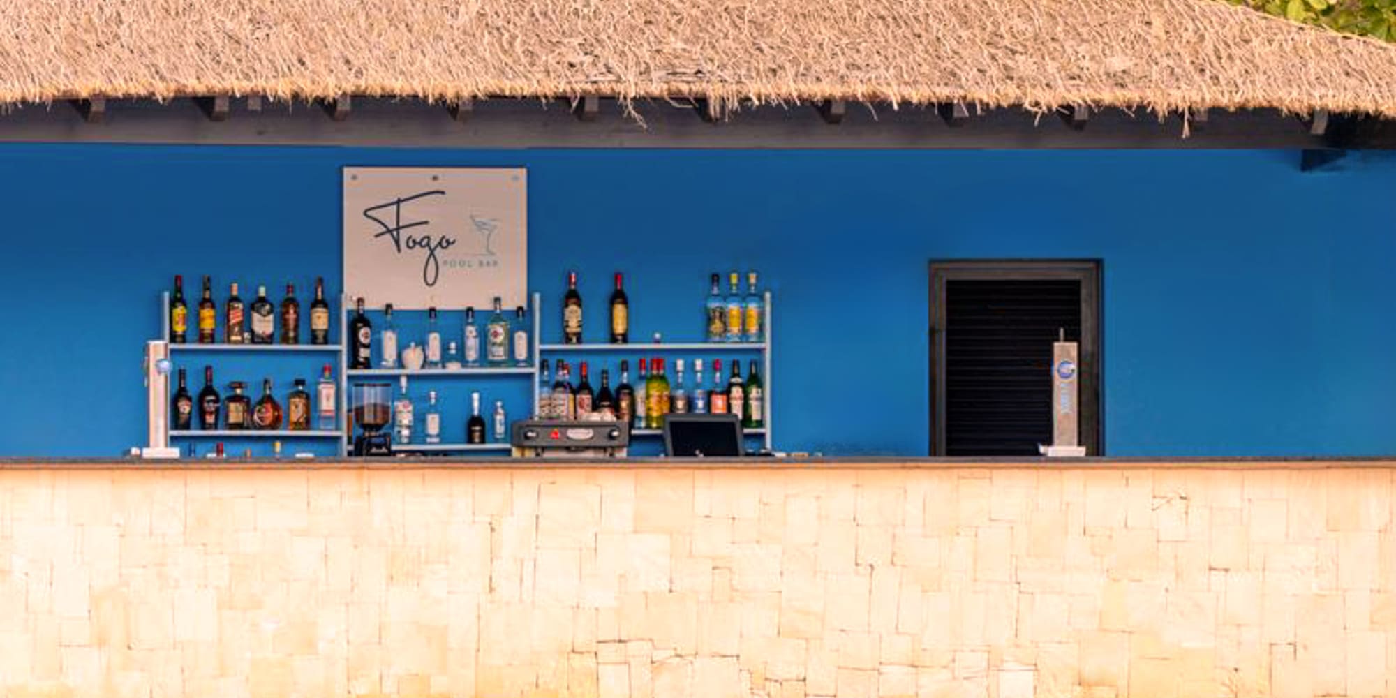 a bar with bottles of alcohol on shelves