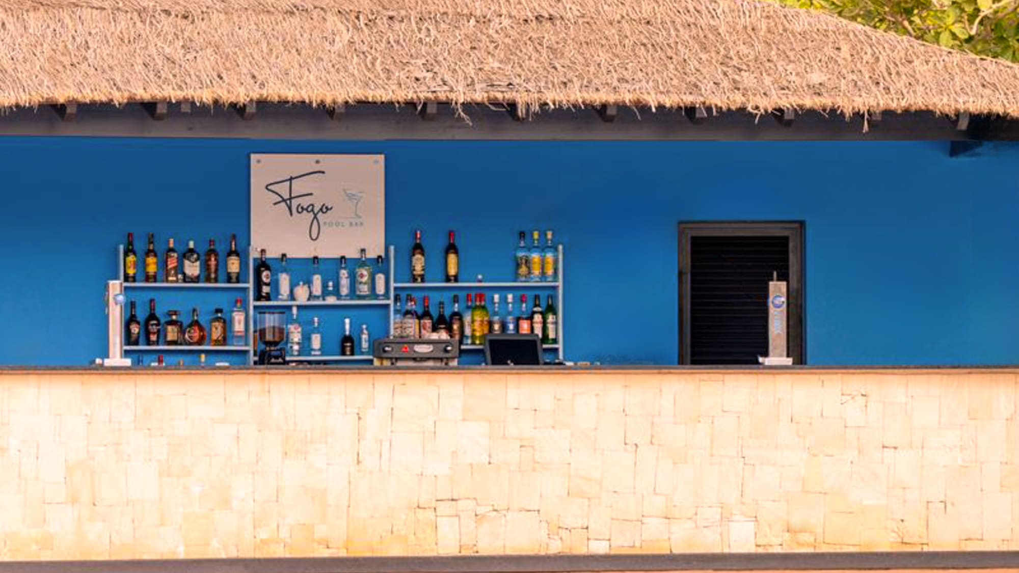 a bar with bottles of alcohol on shelves