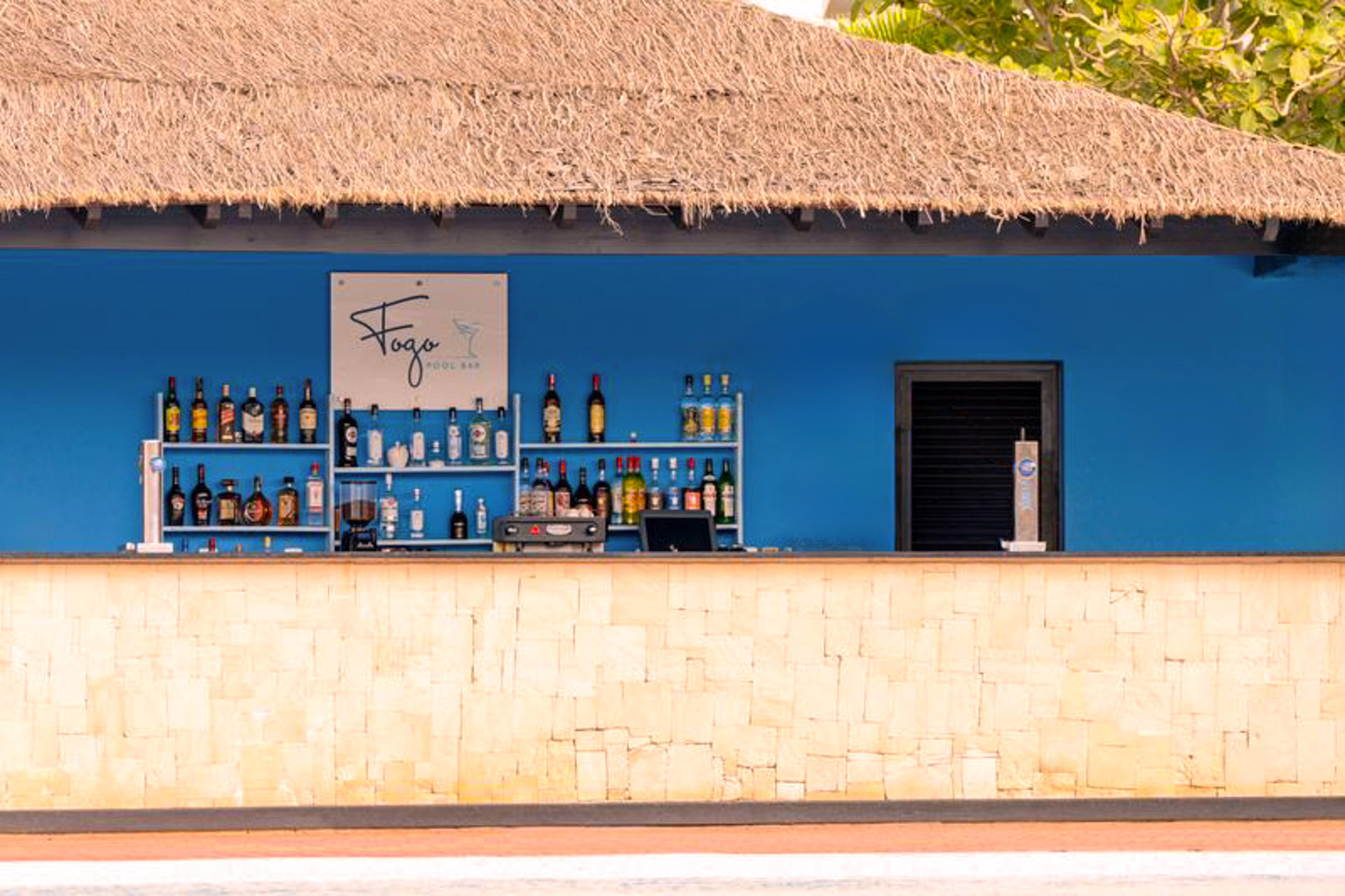 a bar with bottles of alcohol on shelves