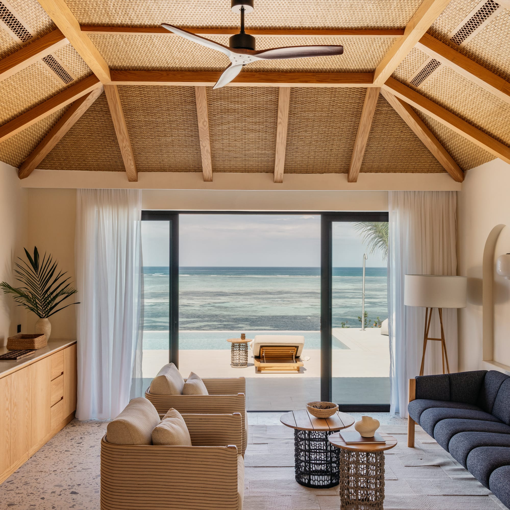 a living room with a view of the ocean