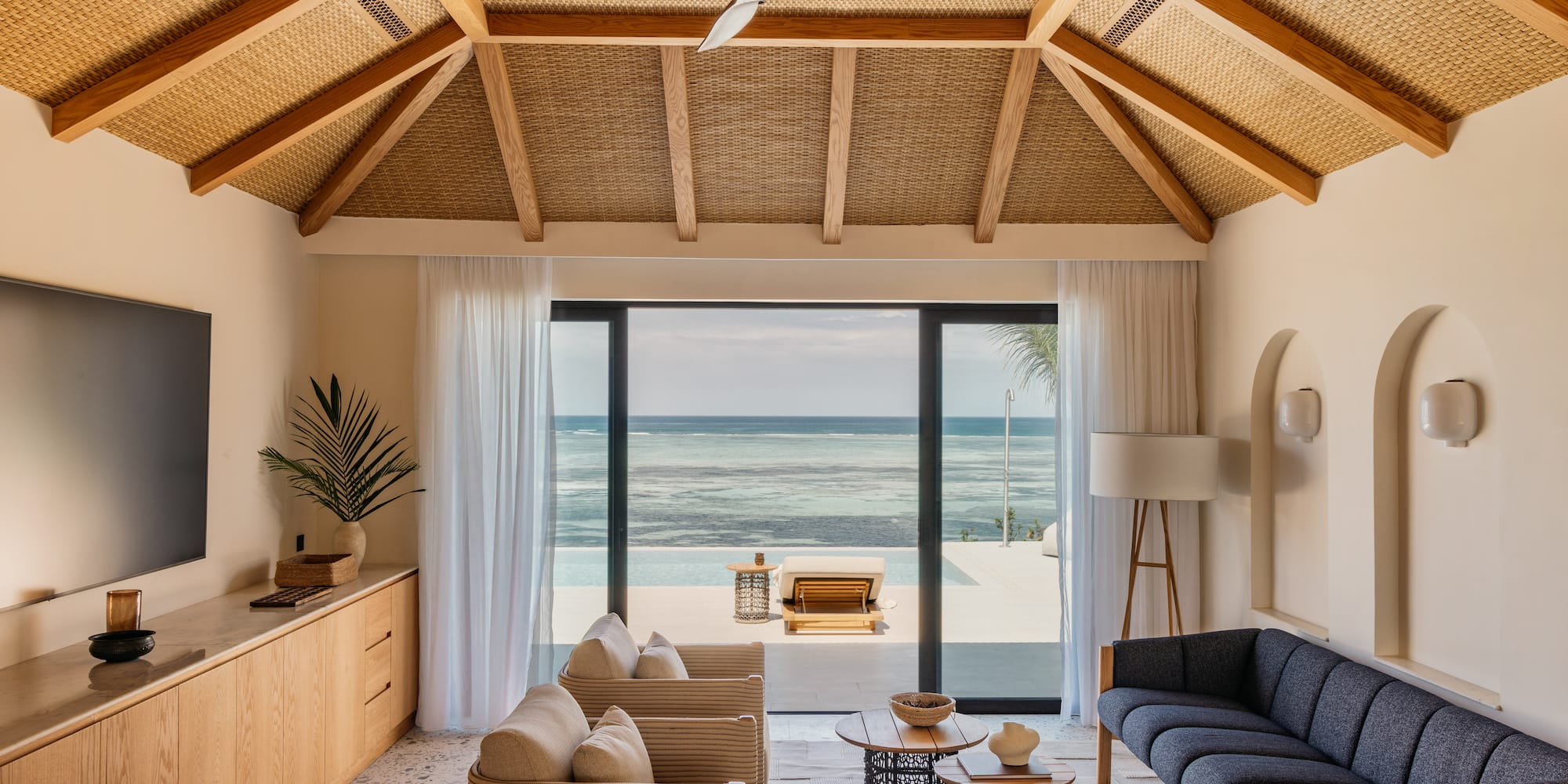 a living room with a view of the ocean
