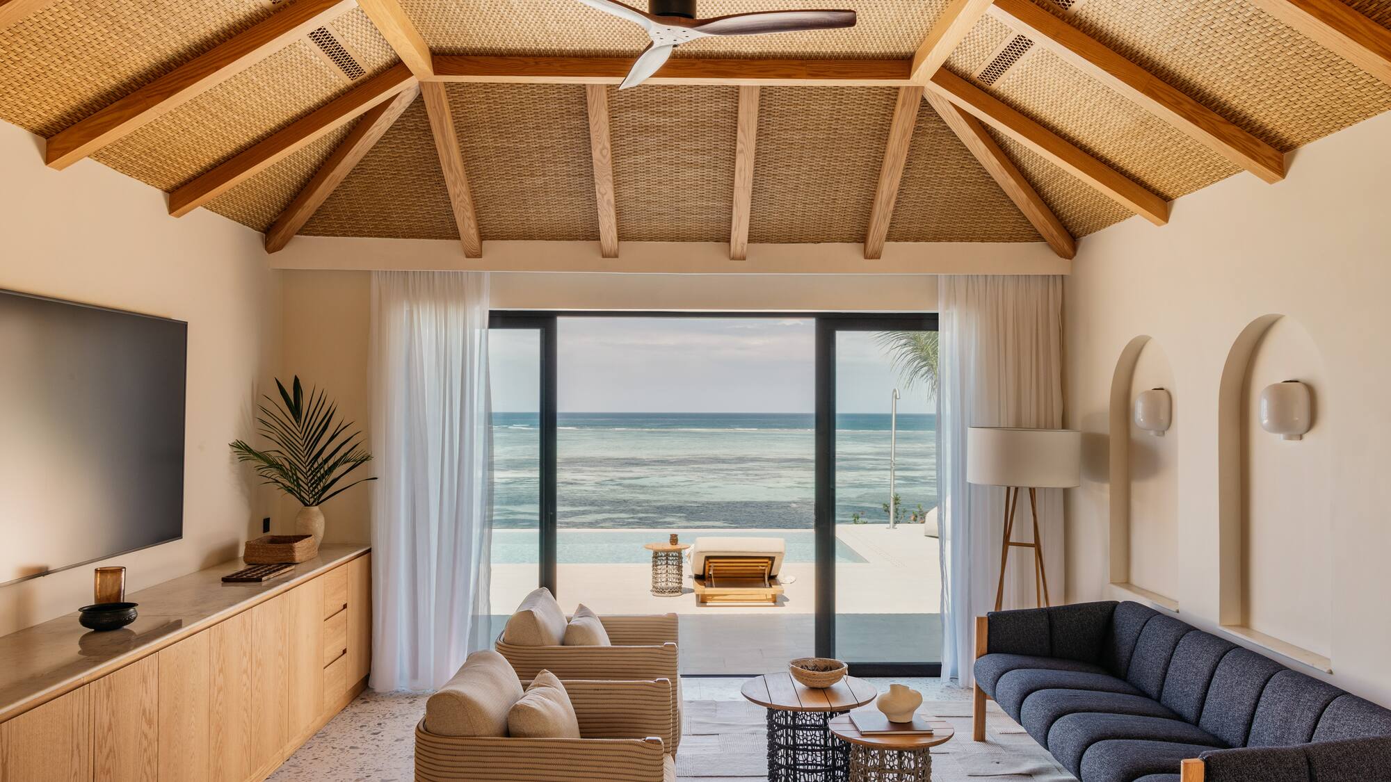 a living room with a view of the ocean