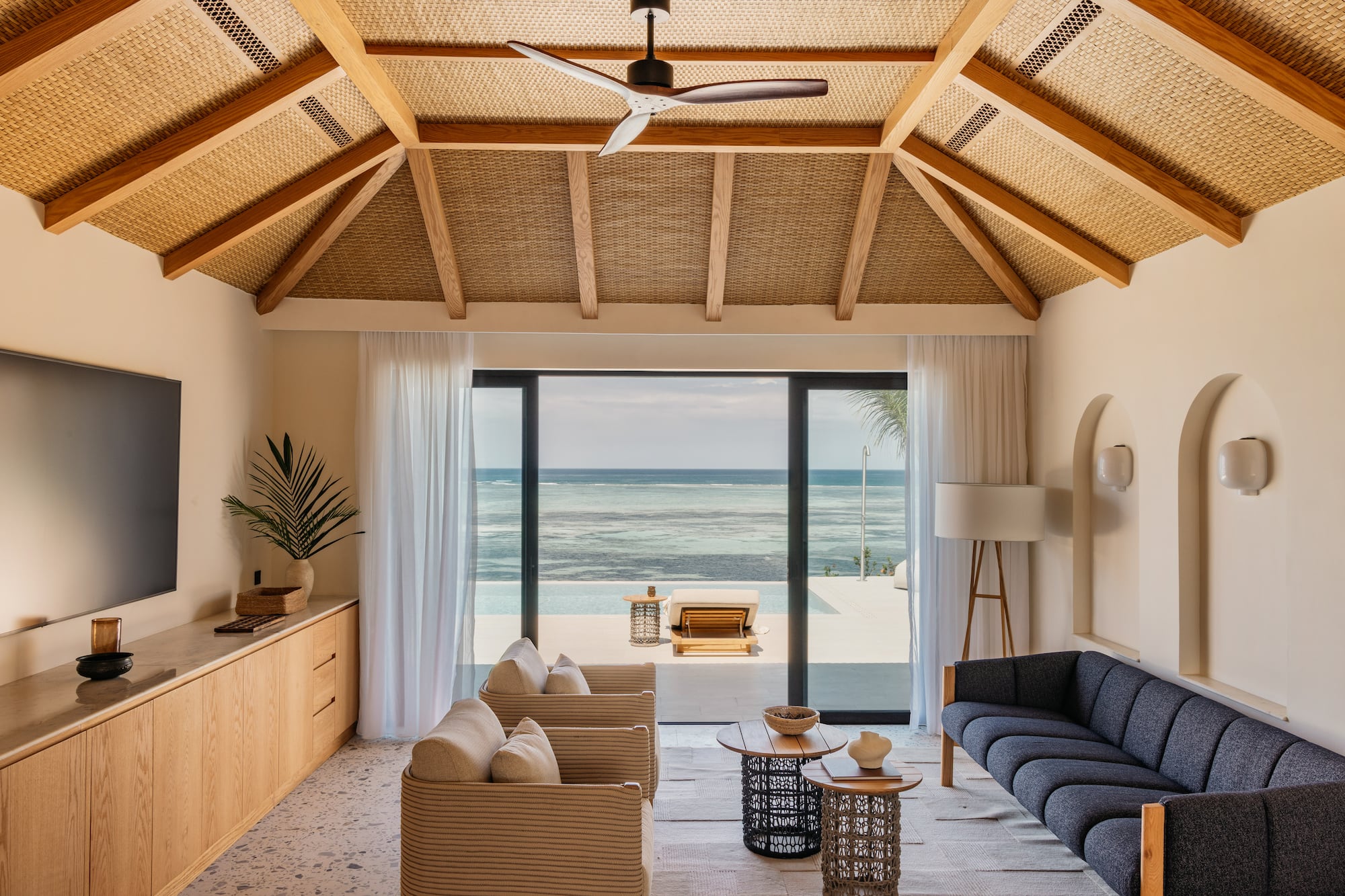 a living room with a view of the ocean
