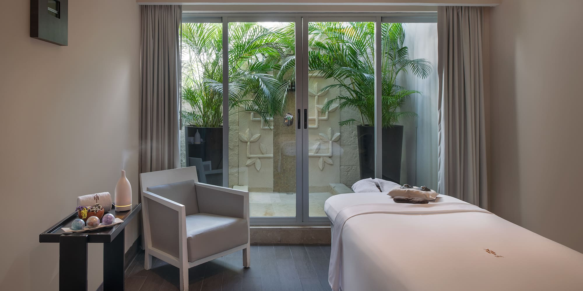 a room with a bed and chairs and a chair