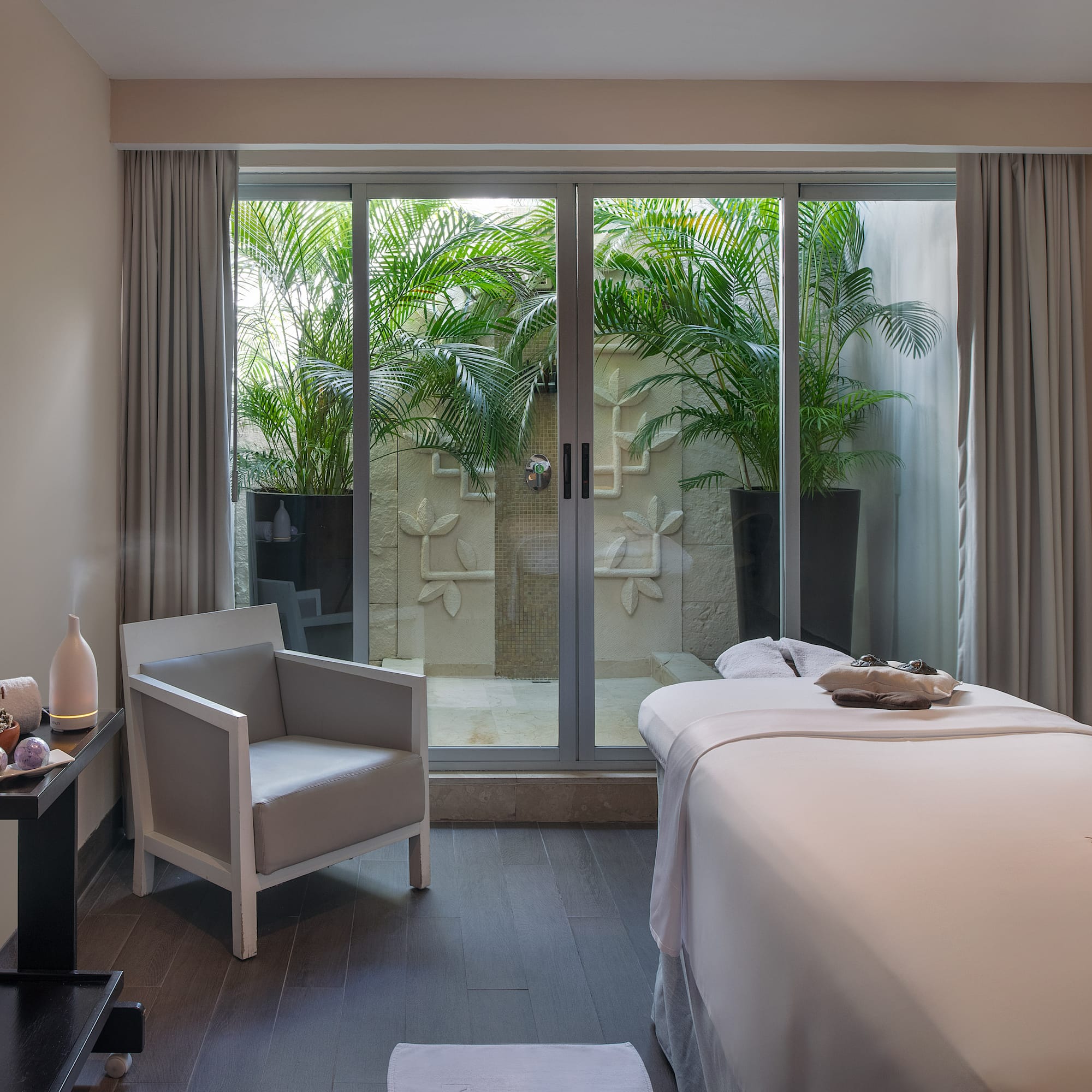 a room with a bed and chairs and a chair