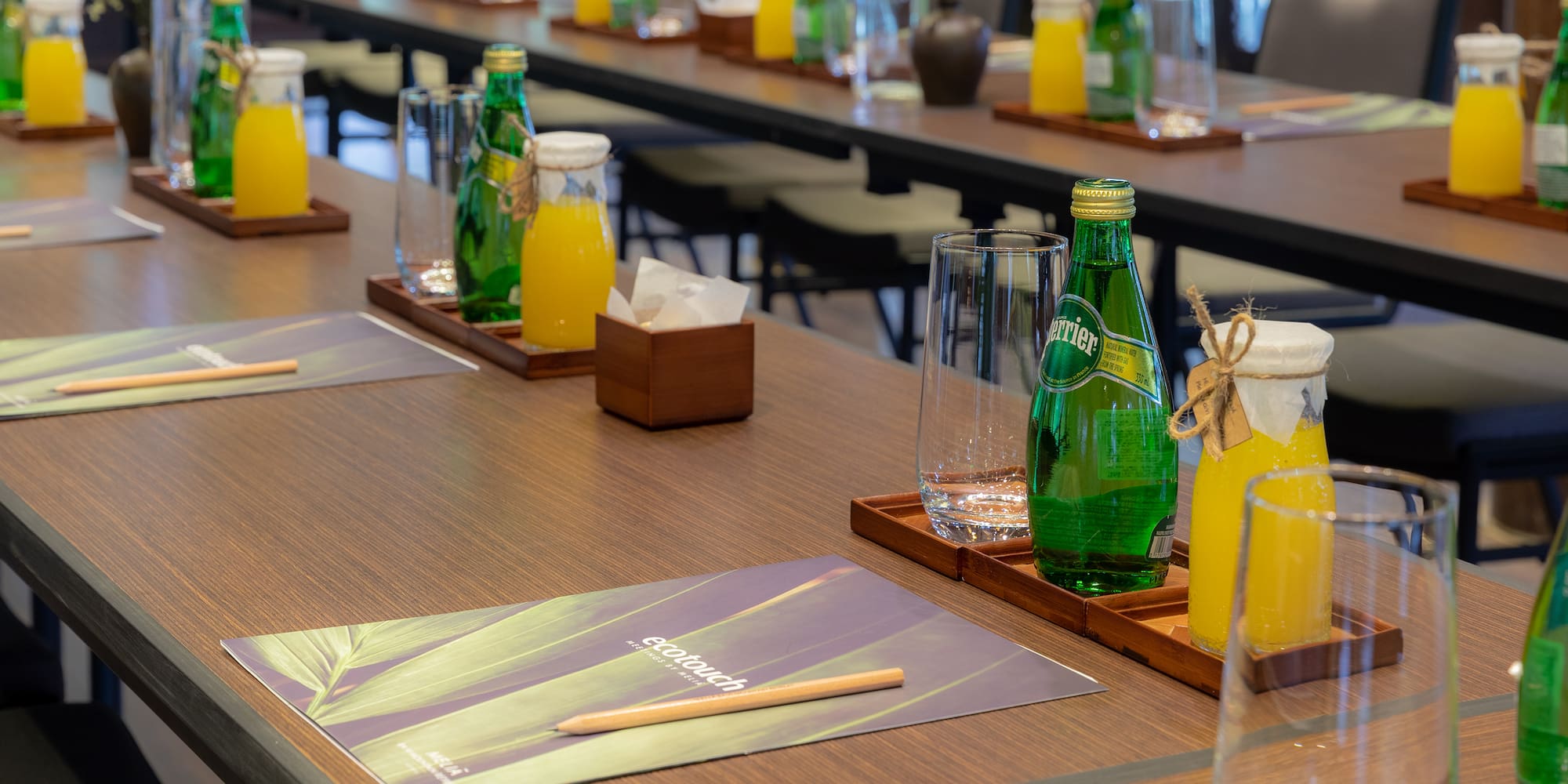 a table with glasses and bottles of juice