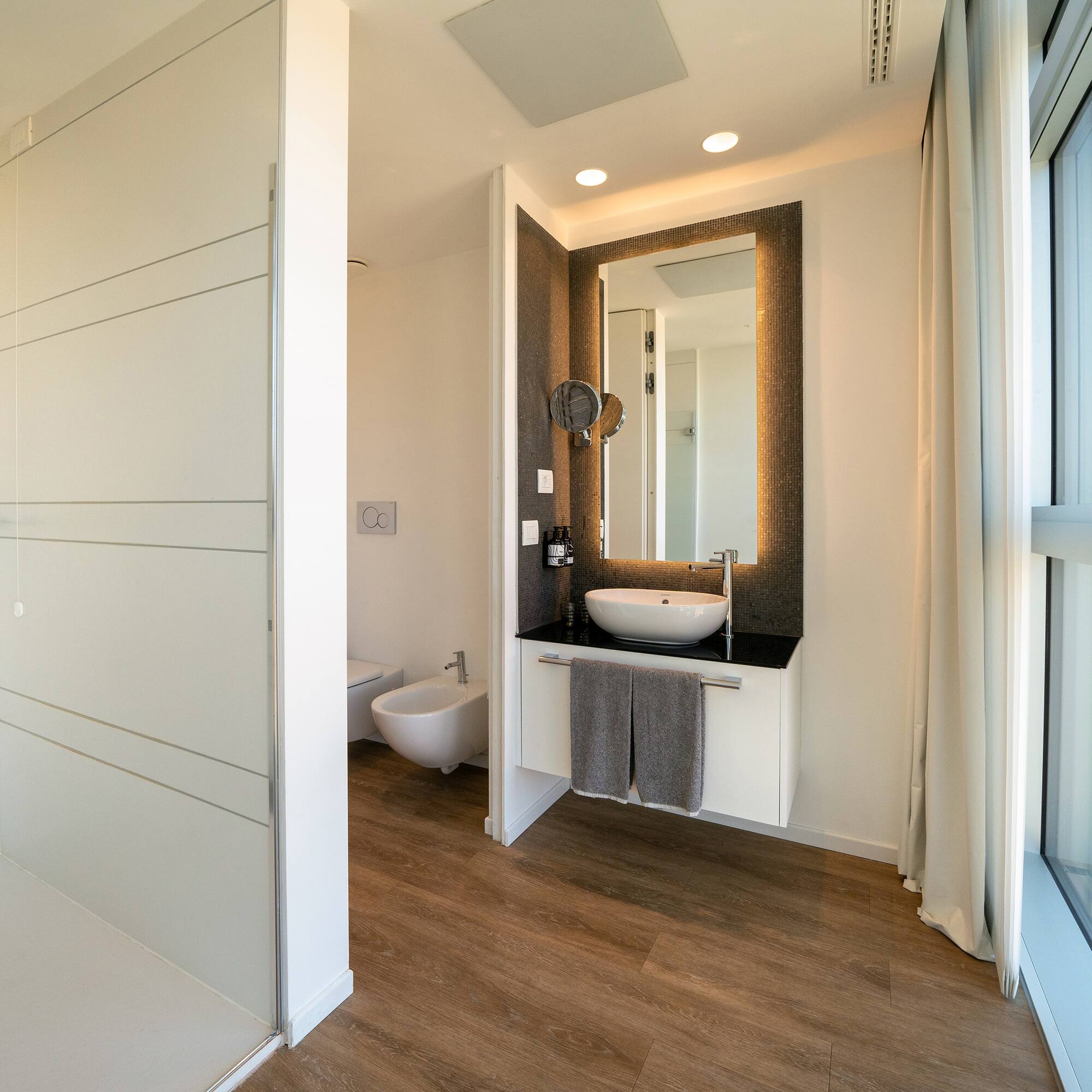 a bathroom with a mirror and a sink