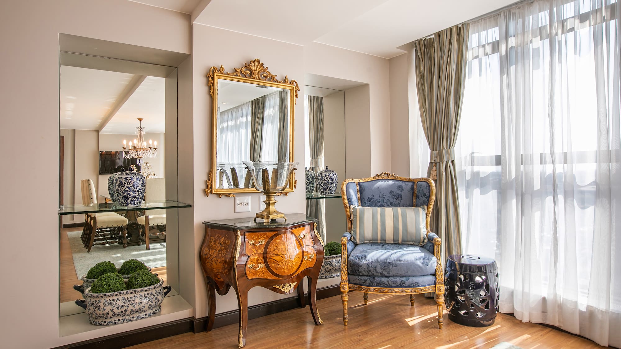 a room with a mirror and a chair