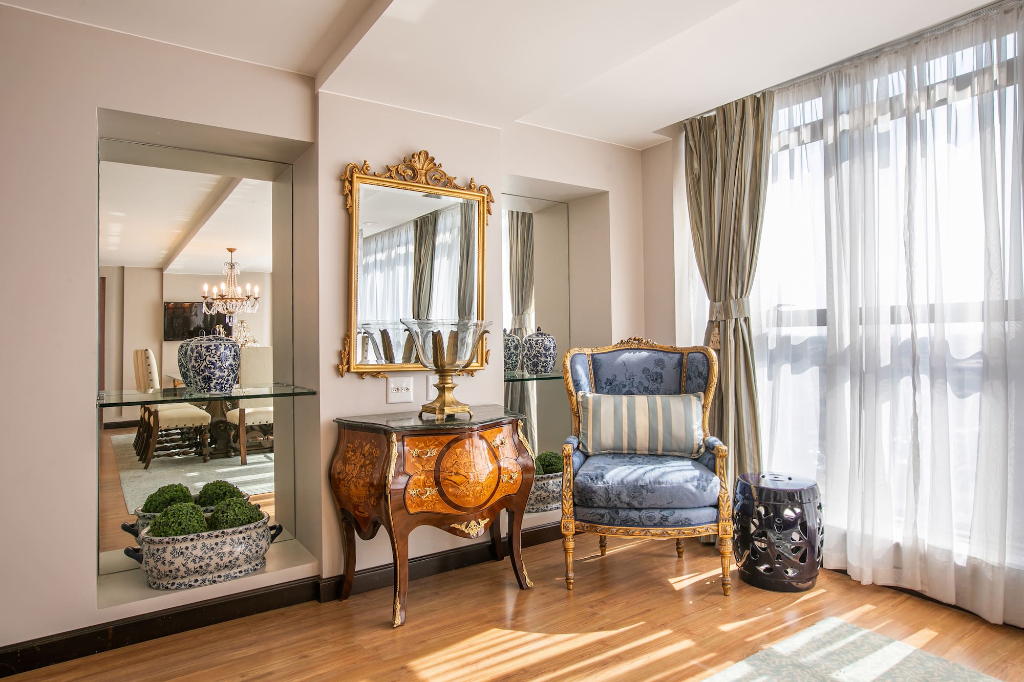 a room with a mirror and a chair