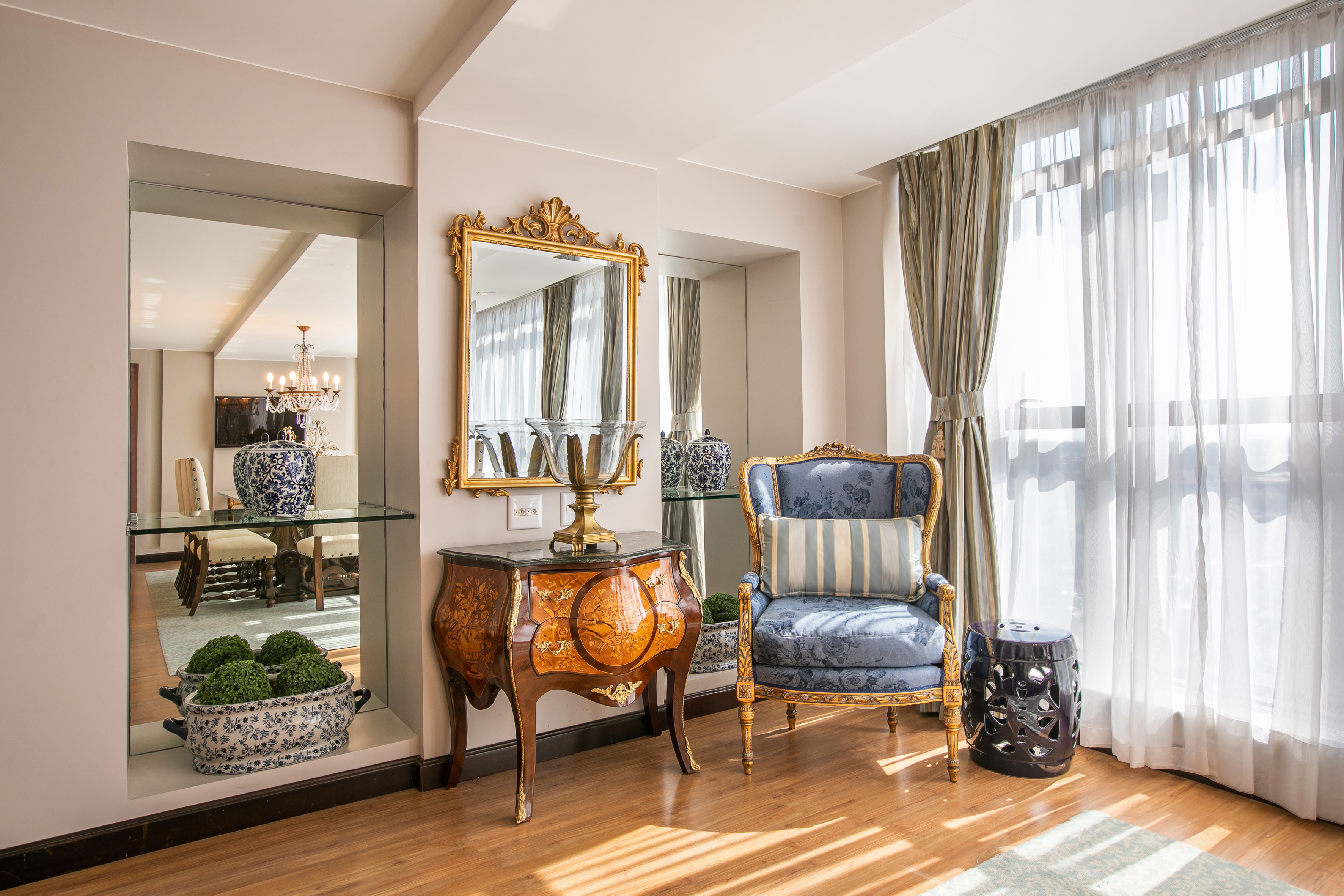 a room with a mirror and a chair