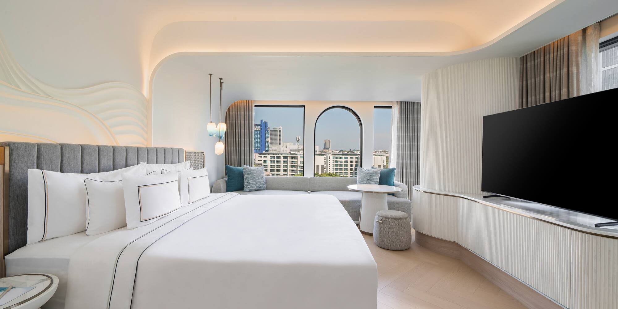 a room with a large bed and a television