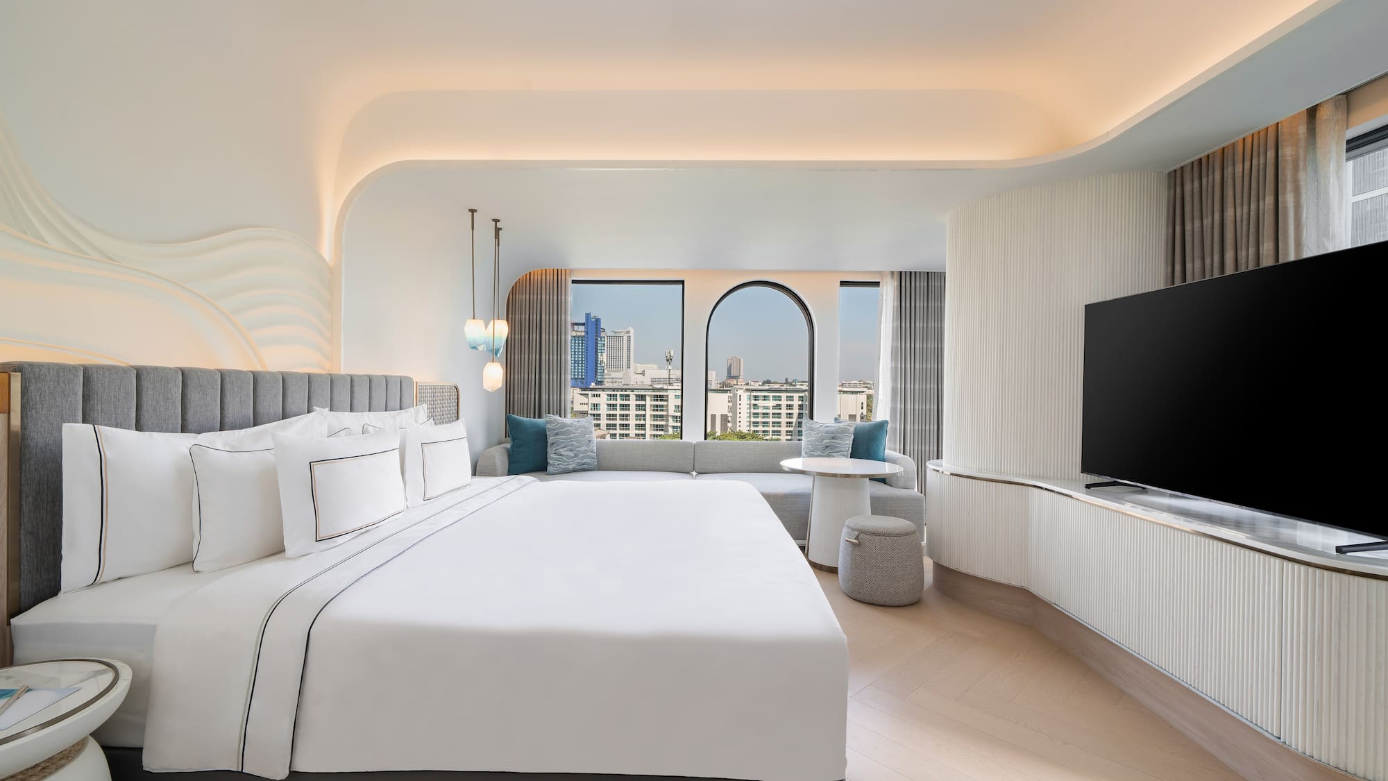 a room with a large bed and a television