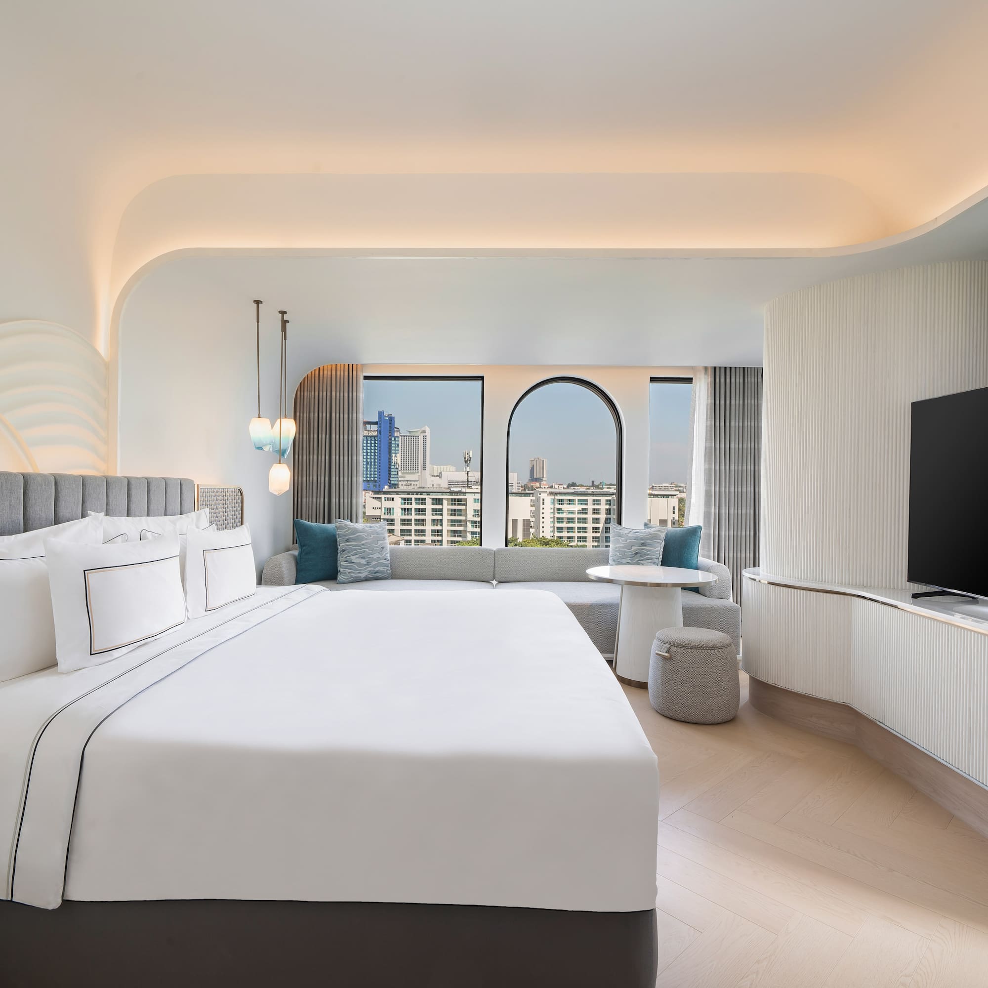 a room with a large bed and a television