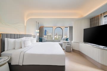 a room with a large bed and a television