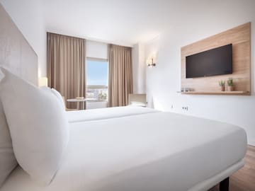 a room with two beds and a tv