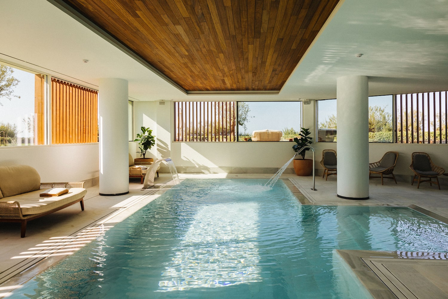 a indoor swimming pool with a waterfall