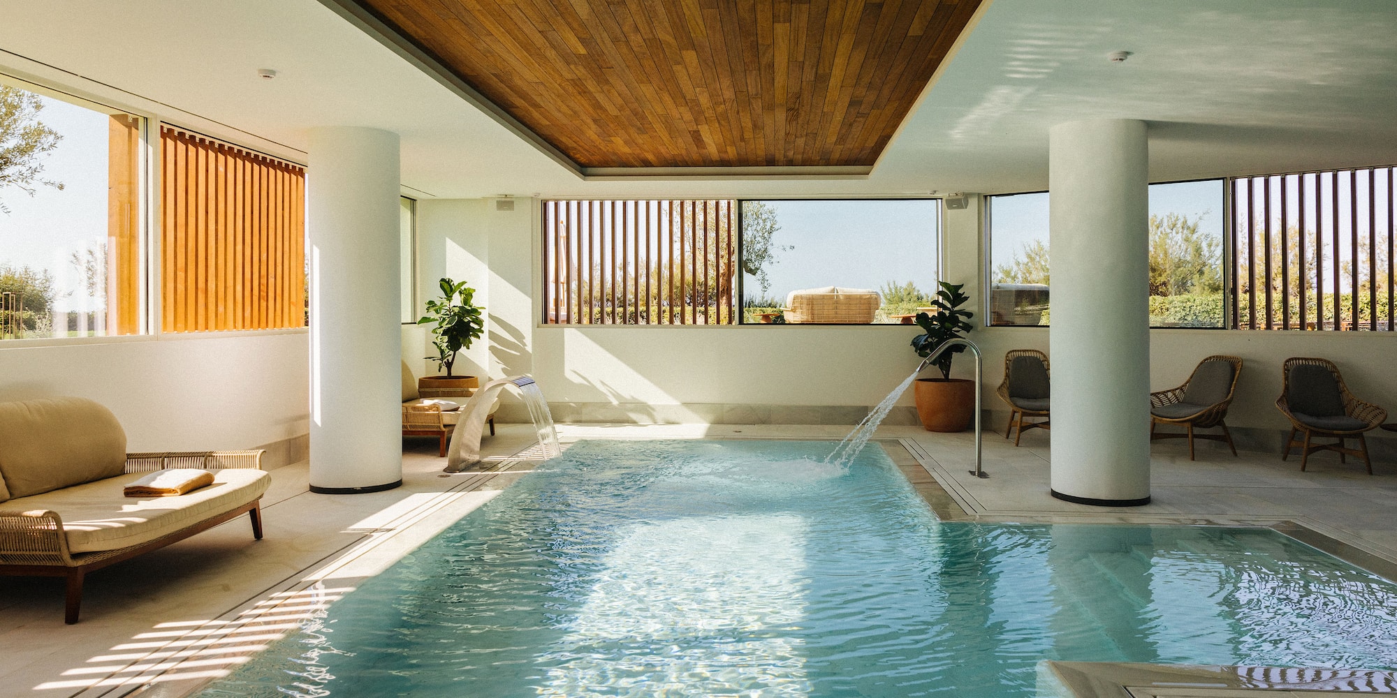 a indoor swimming pool with a waterfall